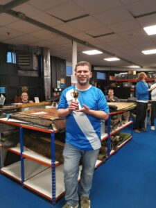 The Champ, Steve, holding up his trophy. Steve is wearing the Waterbowl top from Alicante 2023.
